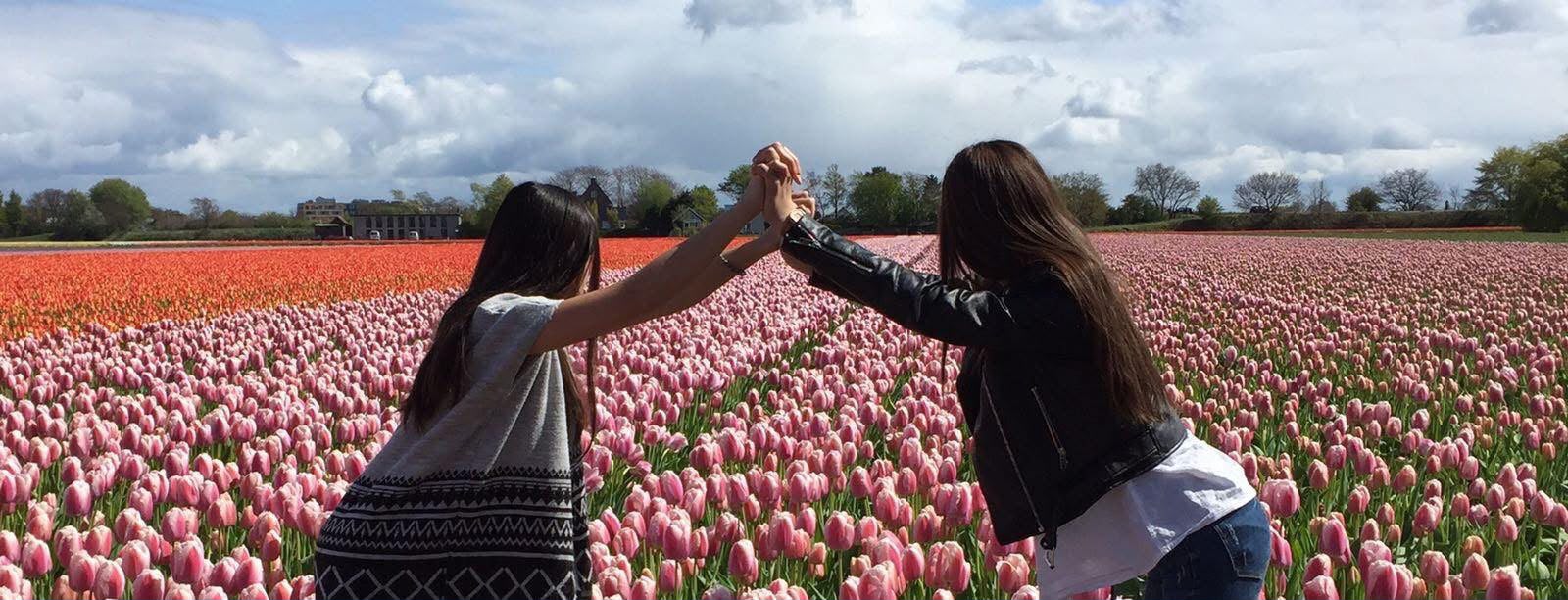 Yana and  her niece holding hands in flowerfield